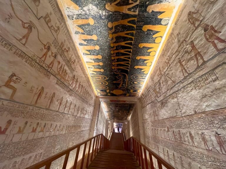 Vividly painted hieroglyphs and reliefs inside the ancient Tomb of Ramesses VI in Egypt's Valley of the Kings. The image captures the deep blue astronomical ceiling and well-preserved mythological scenes, contrasting with the rock-cut walls. Book a direct Nile cruise to explore this UNESCO World Heritage Site in Luxor.