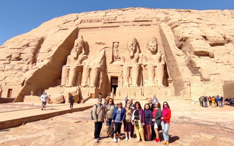 Colossal statues of Ramesses II at the Great Temple of Abu Simbel, viewed from Lake Nasser, a highlight on a luxury Nile cruise itinerary.