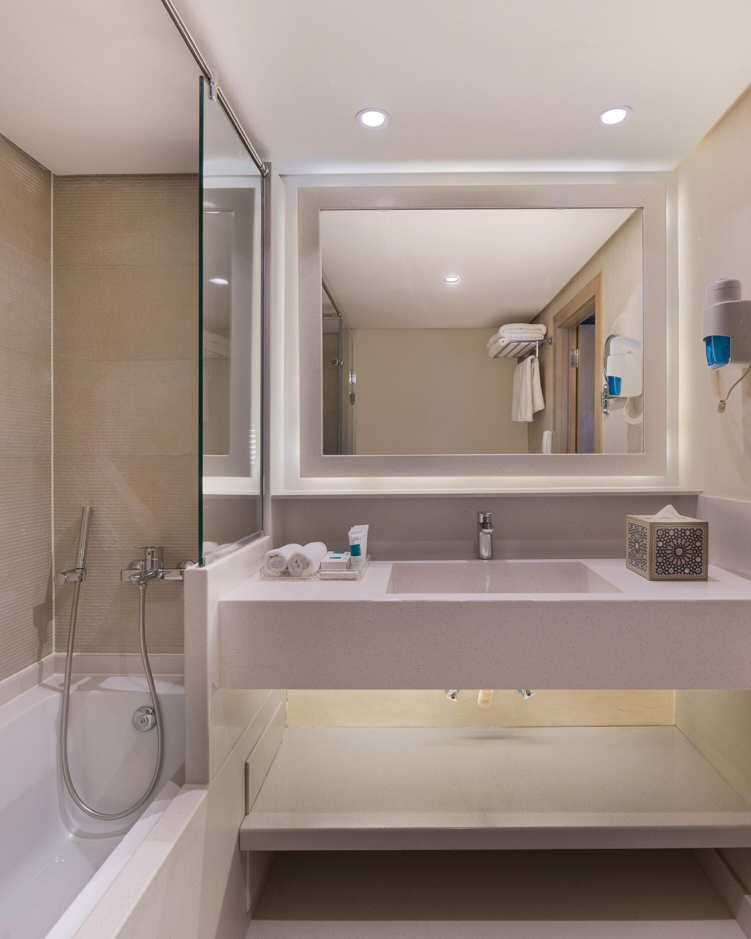 A Jaz Regent Nile Cruise cabin's clean, modern, high-end bathroom with a glass walk-in shower and other high-end features.