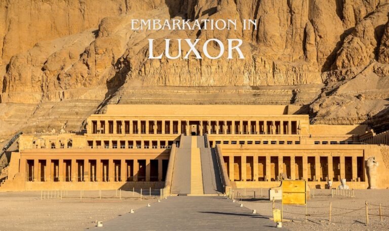 Guests embarking in Luxor with a scenic view of Hatshepsut Temple during a Nile cruise tour in Egypt
