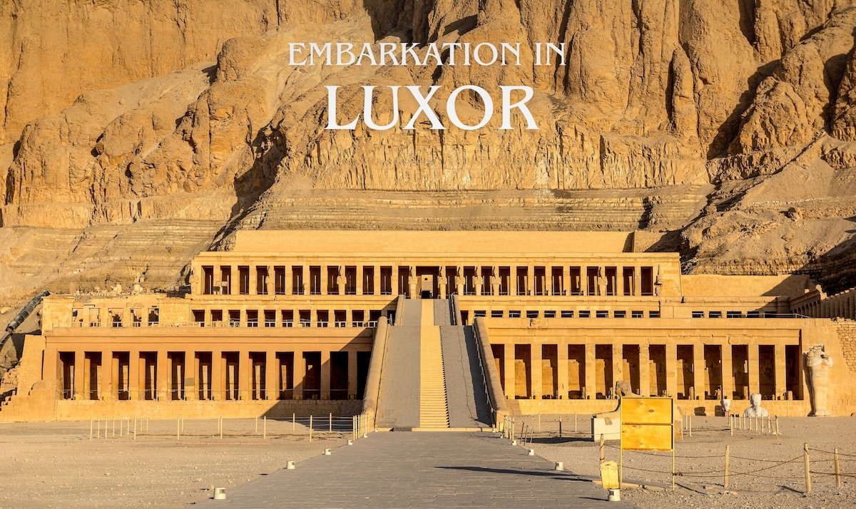 Guests embarking in Luxor with a scenic view of Hatshepsut Temple during a Nile cruise tour in Egypt