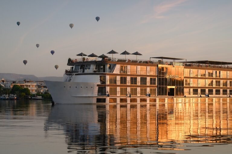 The magnificent soleil luxury Nile cruise sails gracefully down the Nile River in Egypt under a clear blue sky