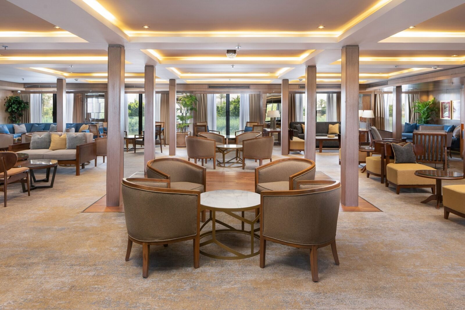 Interior photo of the fully stocked bar and lounge area on the Jaz Regent Nile Cruise, featuring stylish seating and warm overhead lighting.