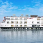 The luxurious Mövenpick MS Hamees Nile cruise ship is sailing on the iconic Nile River, showcasing its modern design and elegant exterior