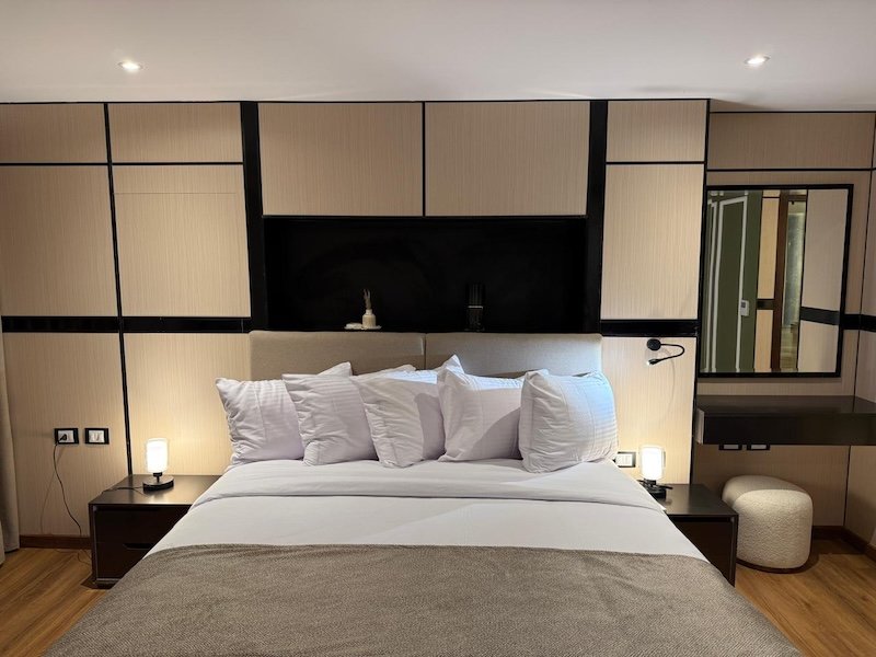 Luxurious Swan Dahabiya suite interior with a panoramic Nile River view.