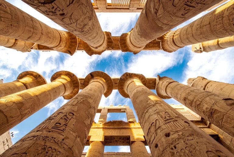 Tourists visiting the ancient Karnak Temple columns in Luxor with Nile Cruisen