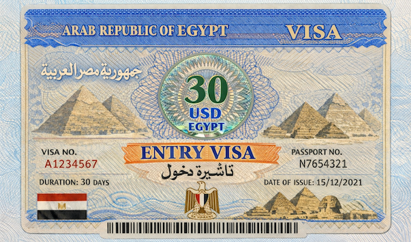 Tourist arriving in Egypt with an entry visa stamp and a view of the Pyramids of Giza in the background