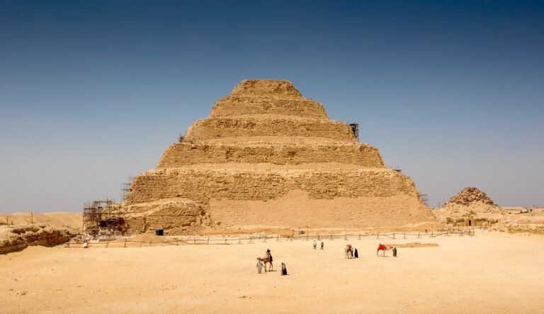 An ancient stone pyramid rising in a desert setting is the Step Pyramid of Djoser in Saqqara, Egypt.
