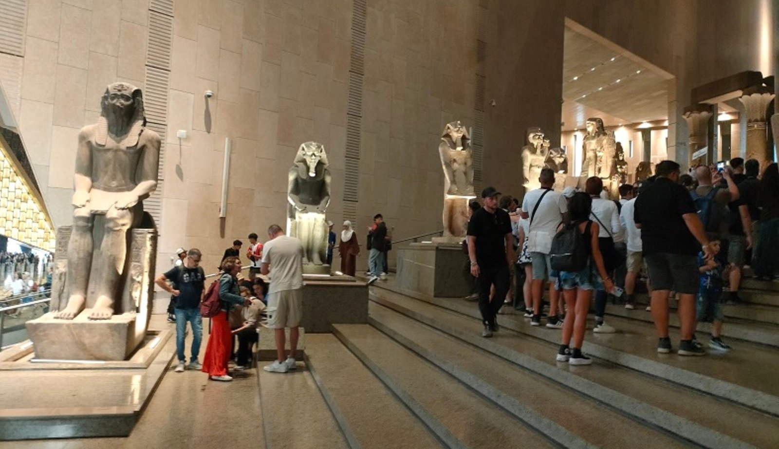 Tourists exploring the Grand Egyptian Museum in Giza near the Pyramids of Egypt