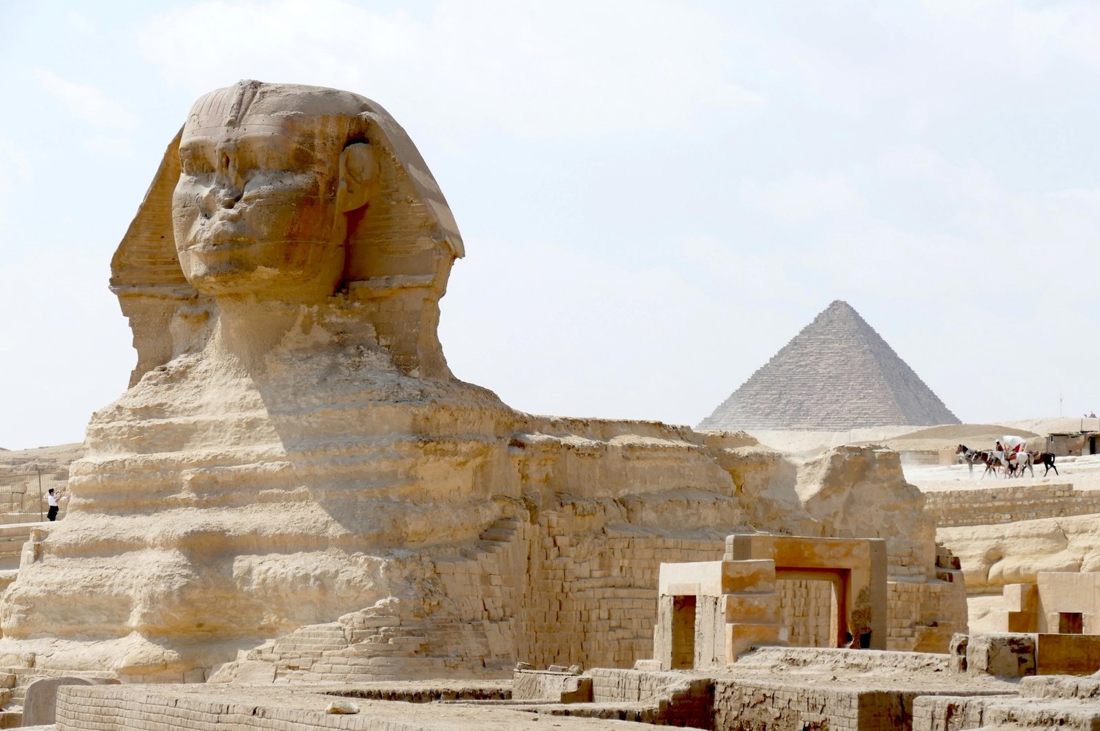 The Great Sphinx of Giza with the pyramids in the background during a guided tour in Egypt with Nile Cruisen.