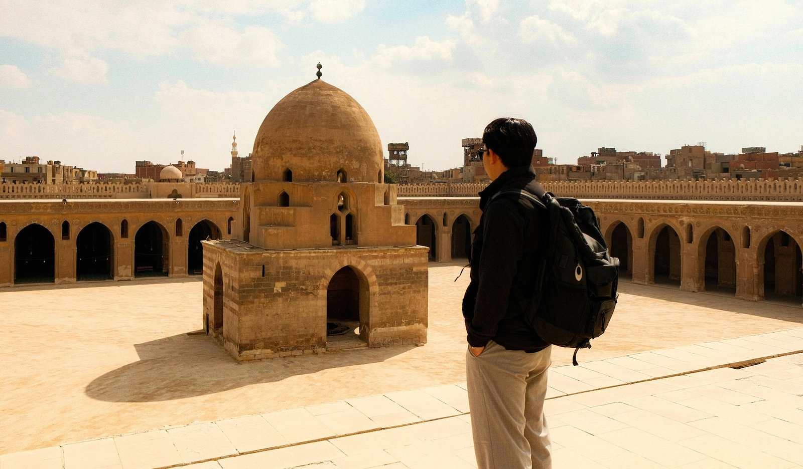 Tourist taking a photo at a historic mosque in Islamic Cairo, Egypt
