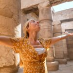 Happy tourist visiting Karnak Temple in Luxor during a guided tour with Nile Cruisen
