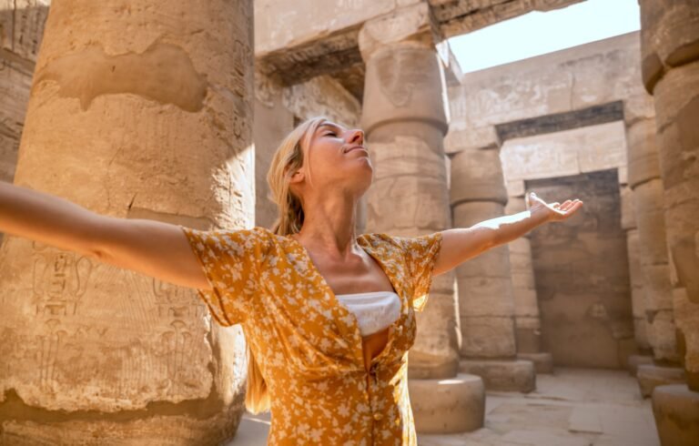 Happy tourist visiting Karnak Temple in Luxor during a guided tour with Nile Cruisen