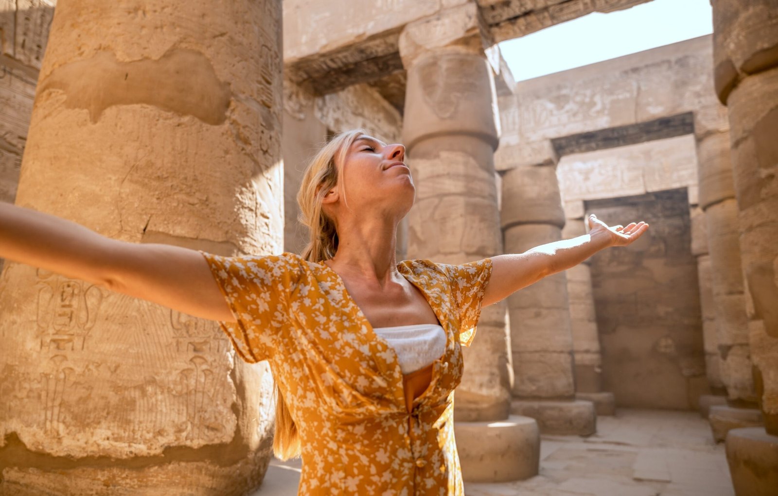 Happy tourist visiting Karnak Temple in Luxor during a guided tour with Nile Cruisen