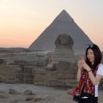 Sunset meditation at the Giza Pyramids surrounded by golden desert views during a spiritual Egypt journey with Nile Cruisen.