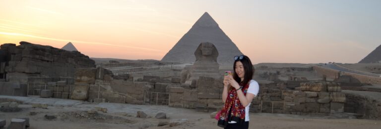 Sunset meditation at the Giza Pyramids surrounded by golden desert views during a spiritual Egypt journey with Nile Cruisen.