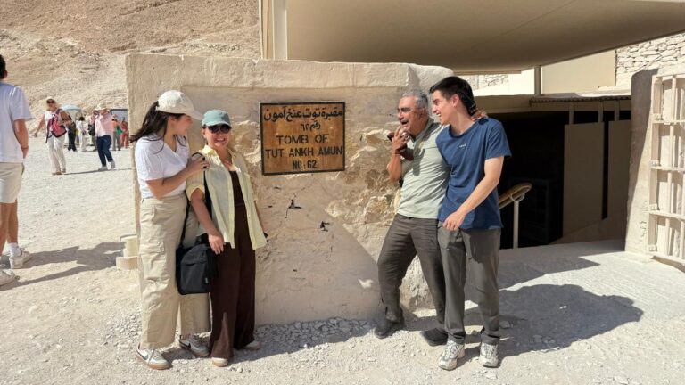 Happy travelers enjoying a luxury Nile cruise in Egypt with Nile Cruisen, relaxing on deck while admiring the scenic Nile River and ancient Egyptian landscapes.