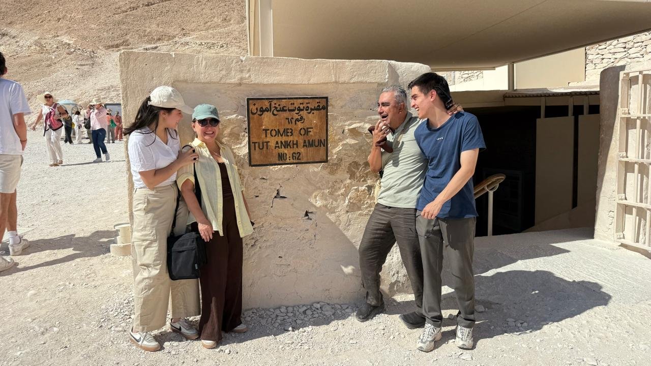 Happy travelers enjoying a luxury Nile cruise in Egypt with Nile Cruisen, relaxing on deck while admiring the scenic Nile River and ancient Egyptian landscapes.