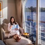 Guest reading a book on a luxury Nile cruise in Egypt
