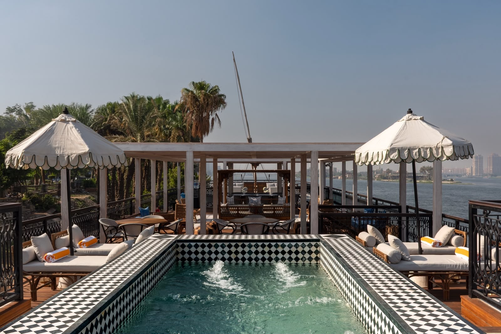 Luxury sundeck on Hayah Dahabiya Cruise sailing the Nile River in Egypt, featuring panoramic river views, comfortable lounge seating, and a relaxing atmosphere. Booked through Nile Cruisen.