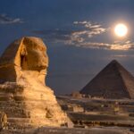 Great Sphinx and Great Pyramid of Giza under a bright moon at night in Egypt