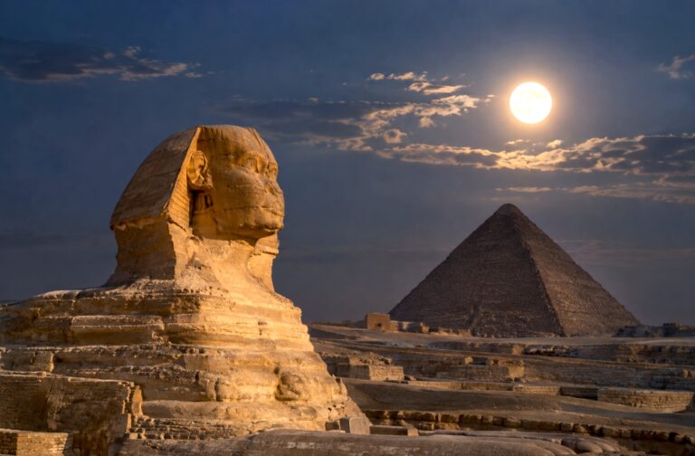 Great Sphinx and Great Pyramid of Giza under a bright moon at night in Egypt